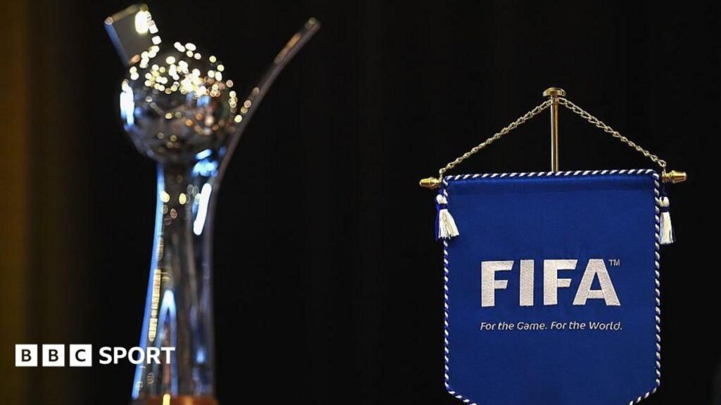 The Women's Under-20 World Cup trophy with a Fifa pendant in the background.