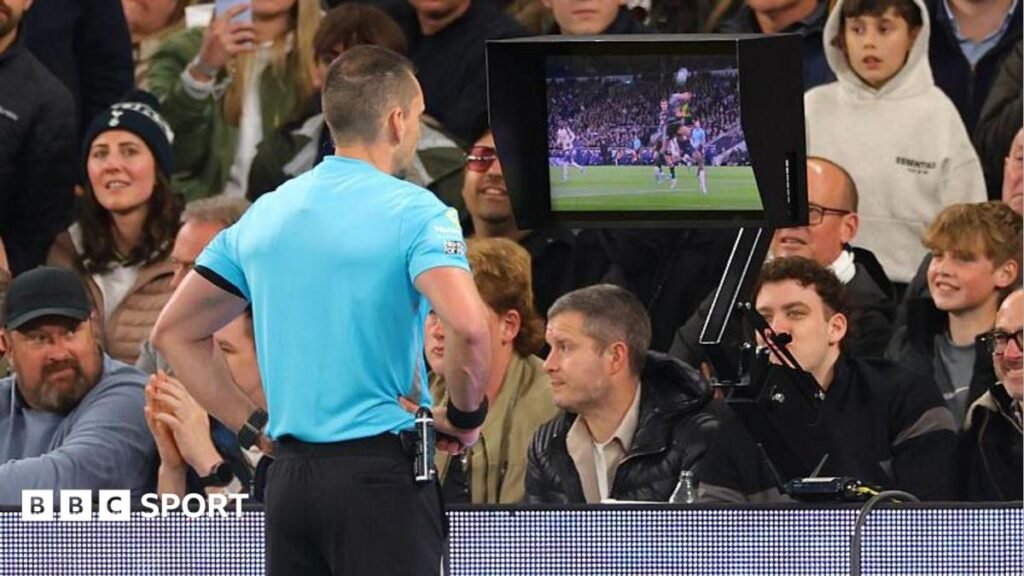 Referee Jarred Gillett reviews the VAR monitor during the Premier League match between Tottenham Hotspur and Leeds United
