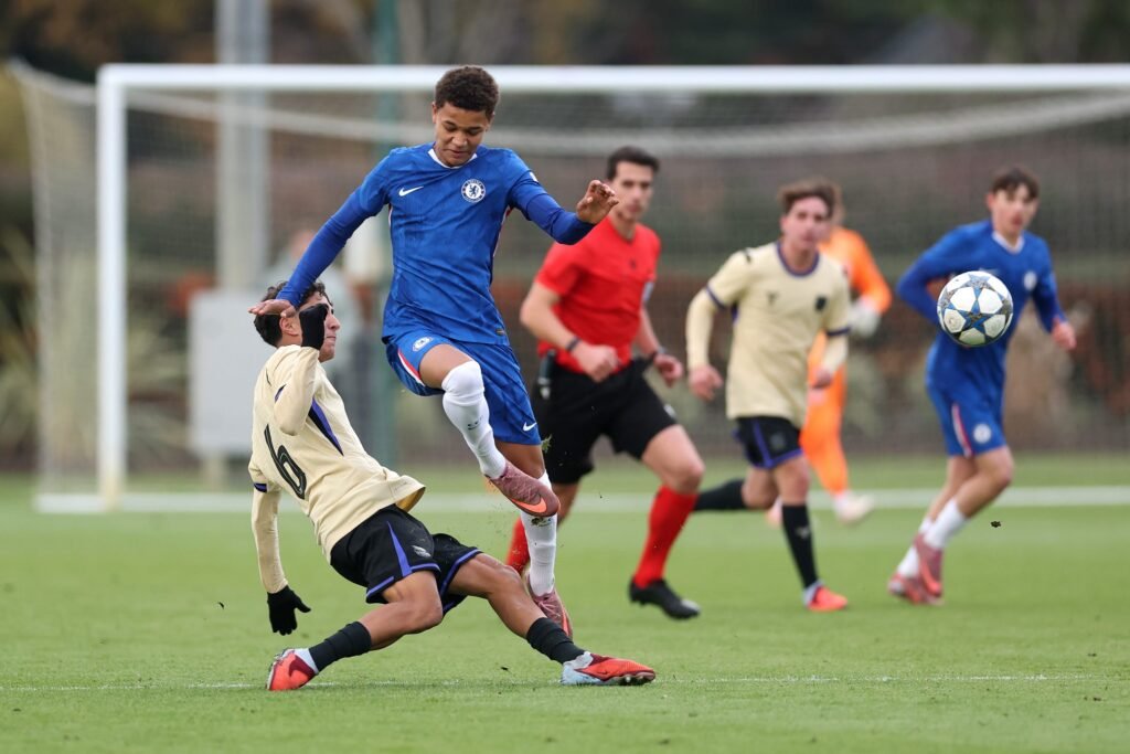 Mahdi Nicoll-Jazuli of Chelsea is challenged by Pedro Villar of FC Barcelona