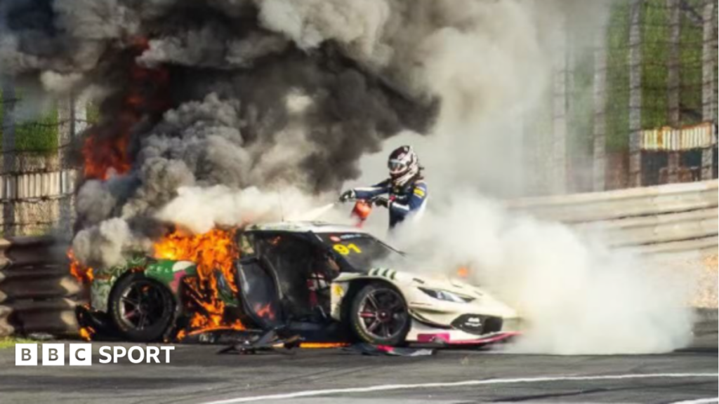 Loek Hartog uses a fire extinguisher on Ollie Millroy's car before pulling him free at the China GT race in Shanghai