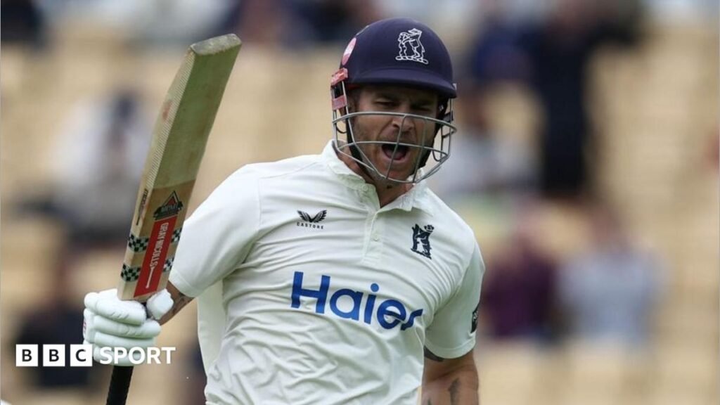 Sam Hain jumps up to celebrate scoring a century