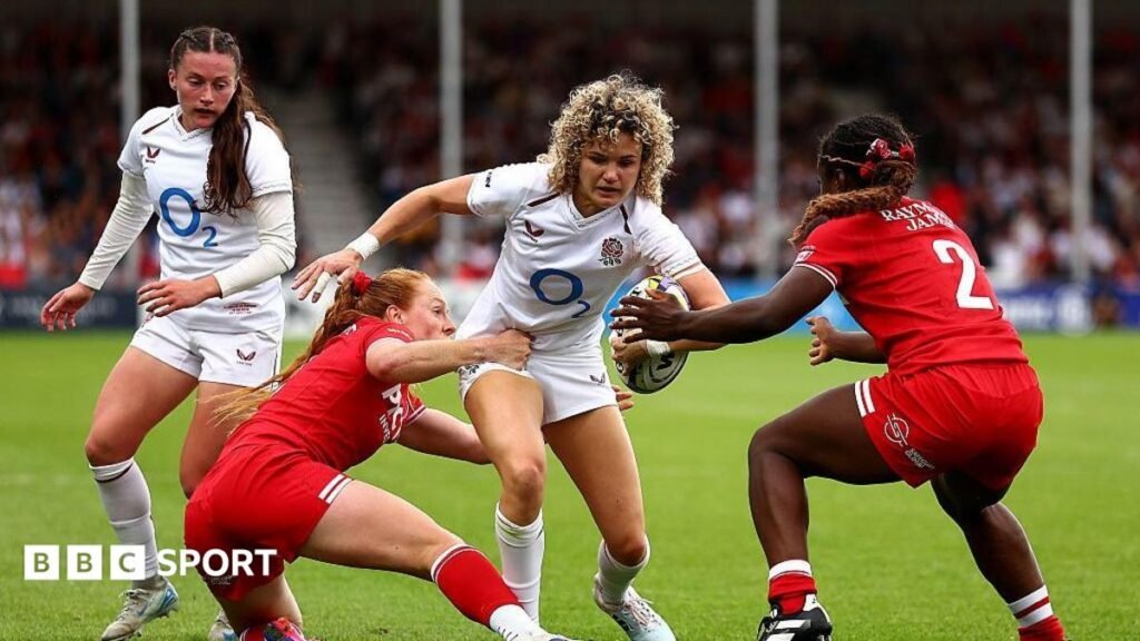 England 26-26 Canada: Red Roses’ 39-game winning run ends with thrilling draw An England player, wearing white, is tackled by two Canada players in red