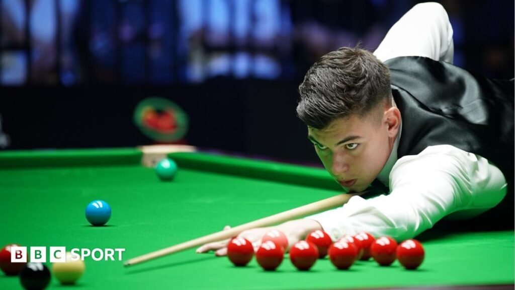 English Open: Liam Davies knocks world champion Wu Yize out of tournament Liam Davies, wearing a white shirt and black waistcoat, leans over the table to play a shot at the Wuhan Open in August