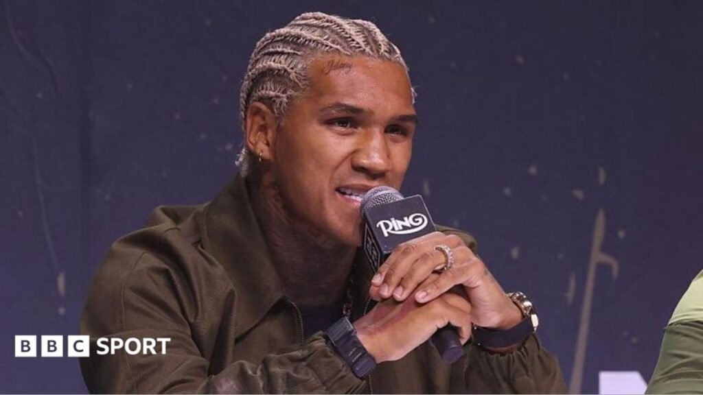 Conor Benn speaks into a microphone at a news conference
