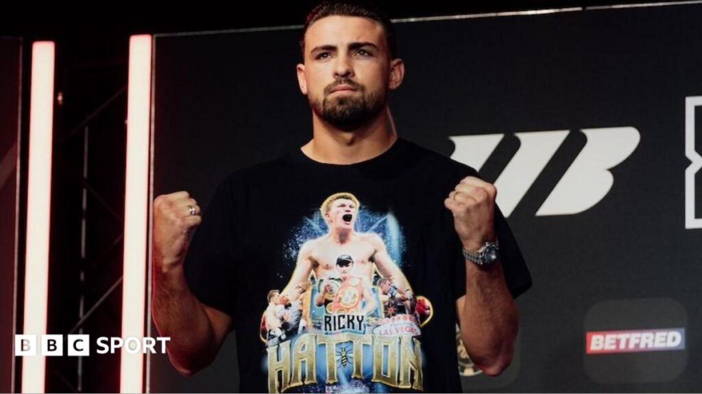 John Hedges vs Pat Brown: Hedges pays tribute to late trainer Ricky Hatton at weigh-in John Hedges holds up his fists and is wearing a black t-shirt with images of Ricky Hatton printed on it