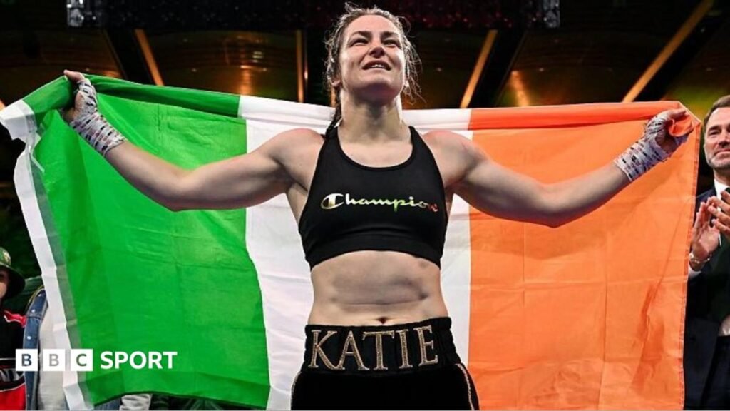 Katie Taylor holds the Ireland flag over her shoulders