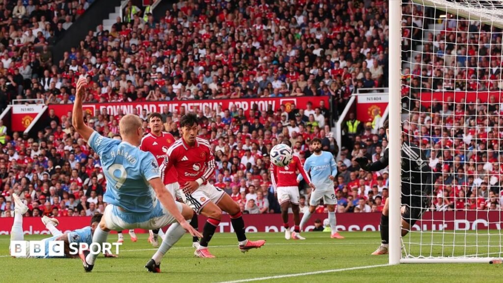 Erling Haaland of Manchester City speaks with referee Michael Oliver as a VAR check is performed after his goal is initially ruled offside