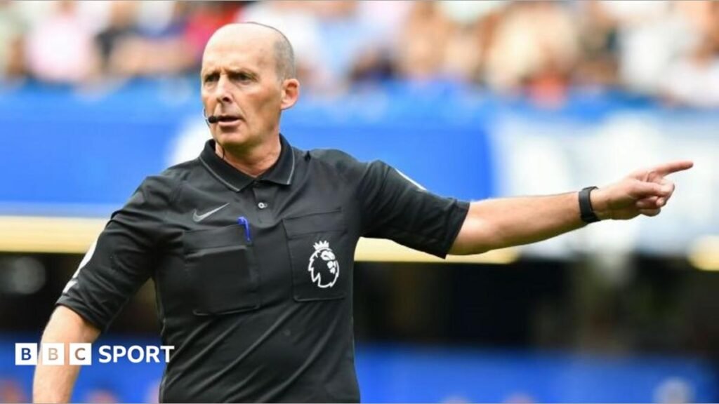 Referee Mike Dean points