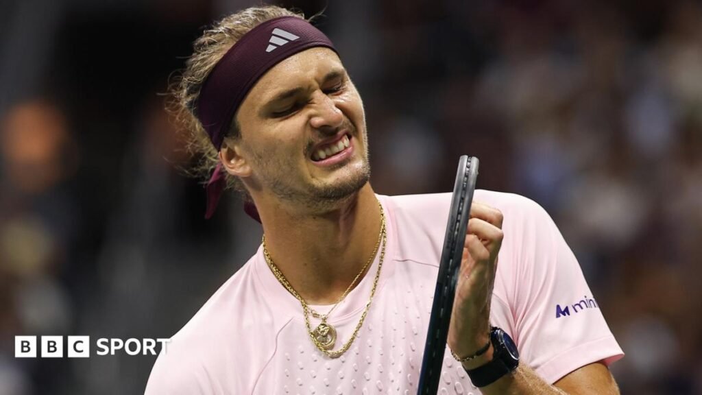US Open 2026 results: Alexander Zverev avoids another shock, Felix Auger-Aliassime out Alexander Zverev, wearing a light pink shirt and with gold jewellery around his neck, grimaces while holding his racquet during his second-round win over Quentin Halys at the US Open