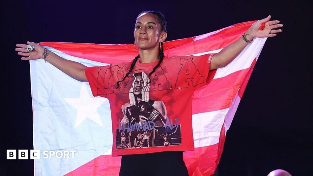 Amanda Serrano poses on the scale at a weigh-in