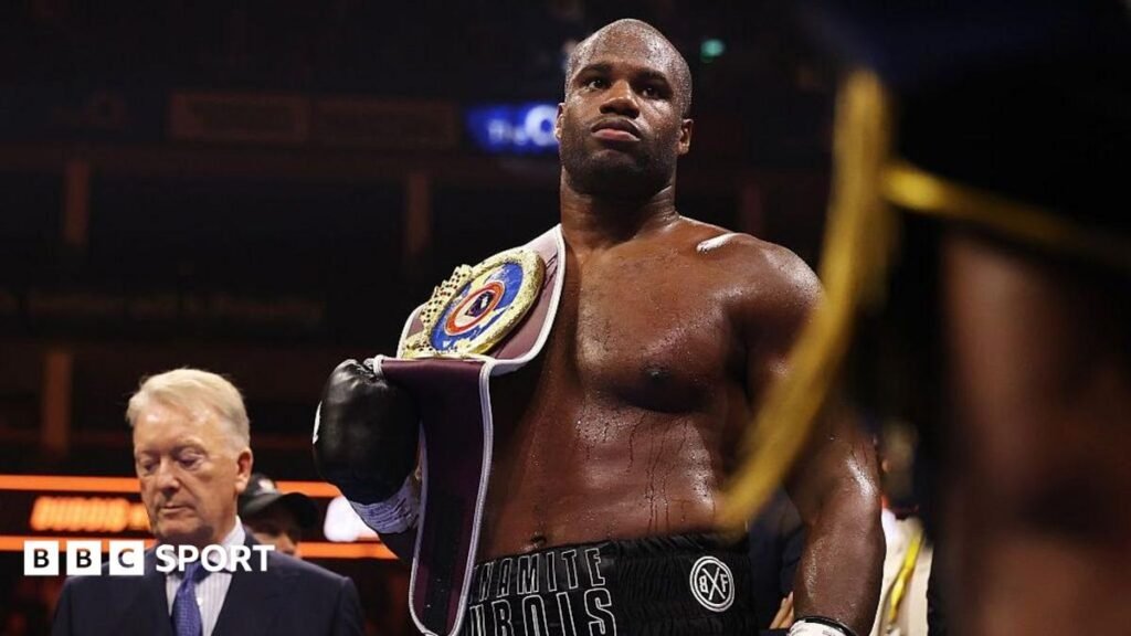 Daniel Dubois has the WBO heavyweight title on his shoulder as Frank Warren stands in the background