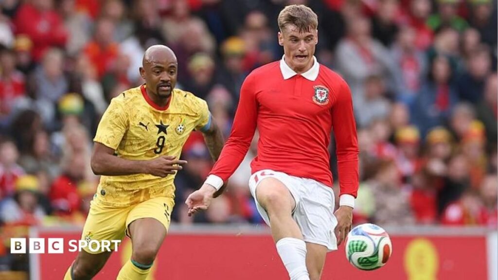 Dylan Lawlor: Cardiff City defender to miss Wales’ November matches Dylan Lawlor in the red shirt of Wales controls the ball under challenge from an opponent in yellow