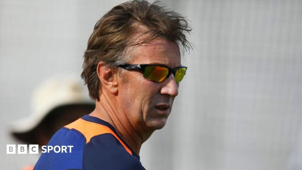 A headshot of Eric Simons wearing sunglasses