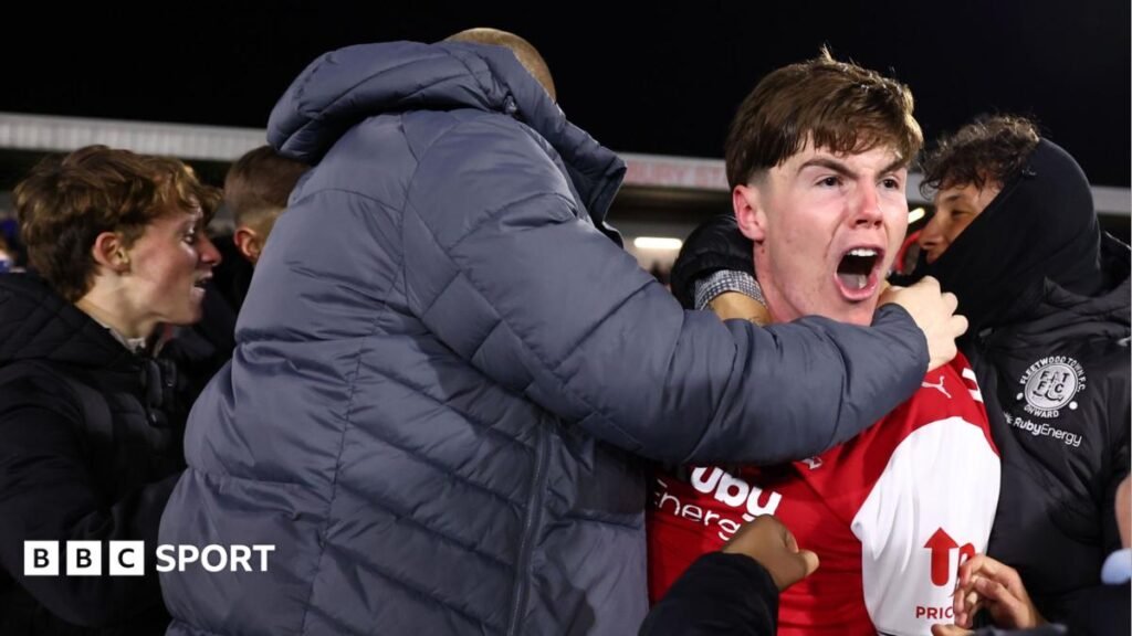 Conor Haughey celebrates with Fleetwood's fans who swarmed the pitch after their EFL Cup win against Arsenal