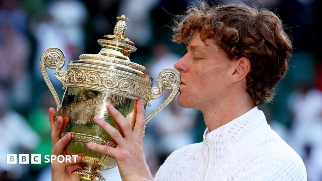 Jannik Sinner kisses the Wimbledon trophy after beating Alexander Zverev in the men's final