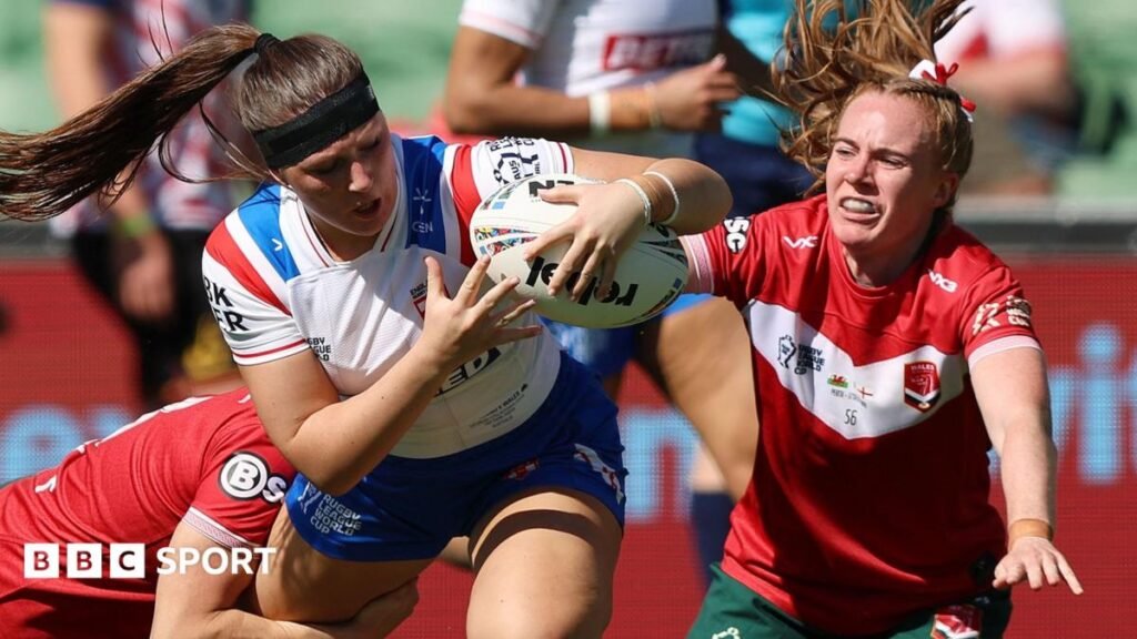 Connie Boyd holds on to the ball as two Wales players look to halt her progress