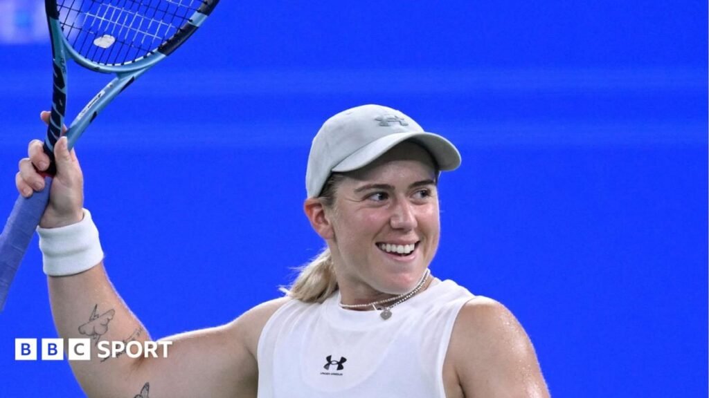 Sonay Kartal smiles and raises her racquet to the air after beating Jelena Ostapenko in the Wuhan Open semi-finals